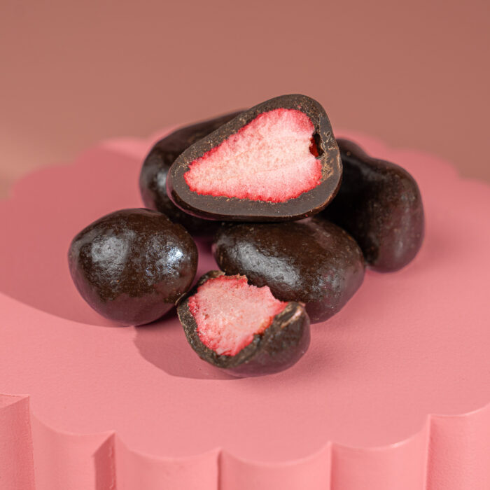 A premium gourmet treat of freeze-dried strawberries coated in rich black chocolate (50%+ cacao), offering a perfect balance of deep cocoa flavour and natural fruit sweetness.