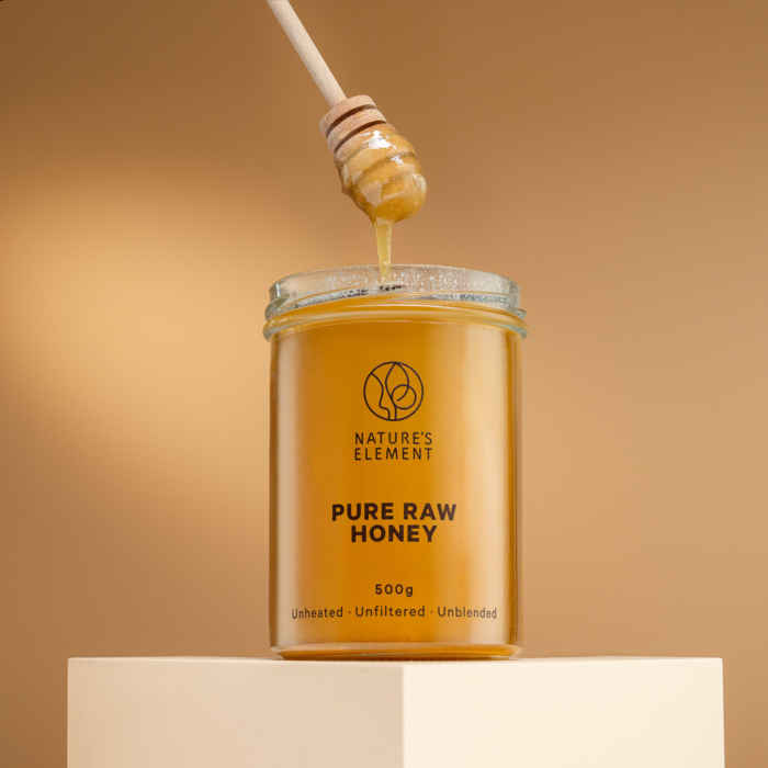 Nature’s Element pure raw honey in glass jar on beige background – unheated, unblended, unfiltered natural EU honey