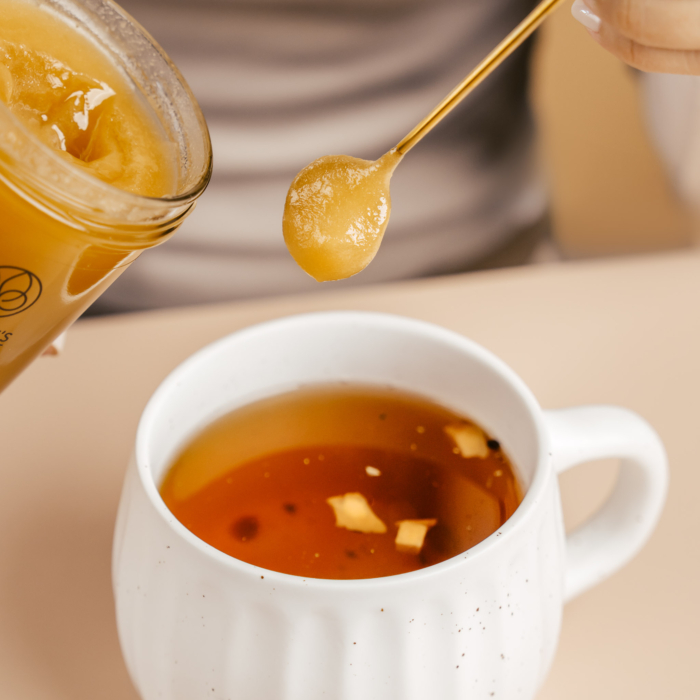 Spoonful of Nature’s Element raw honey added to cup of tea – natural unheated sweetener