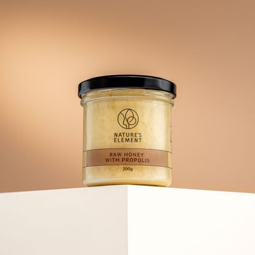 Nature’s Element – Raw Honey with Propolis 200g Nature’s Element raw honey with propolis in glass jar on beige background – natural immune-boosting honey