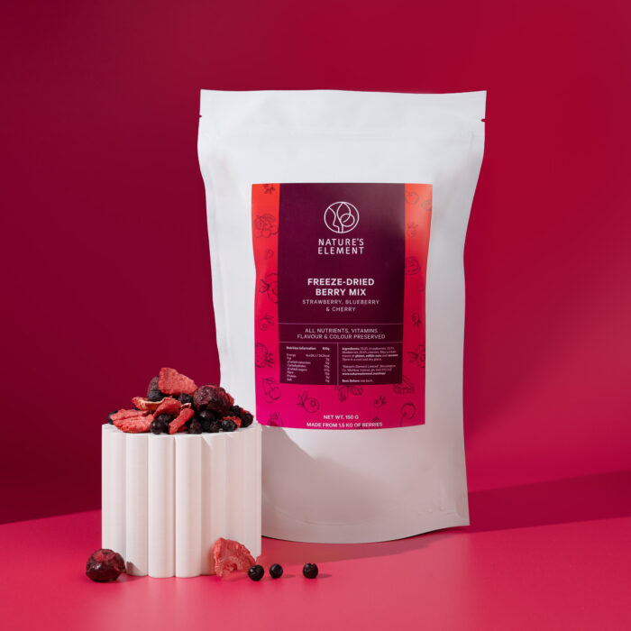 Freeze-dried berry mix 150g package by Nature's Element with strawberry slices, blueberries and cherries displayed on white pedestal