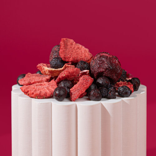 Close-up of freeze-dried strawberry slices, blueberries and cherries showing texture and vibrant natural colours